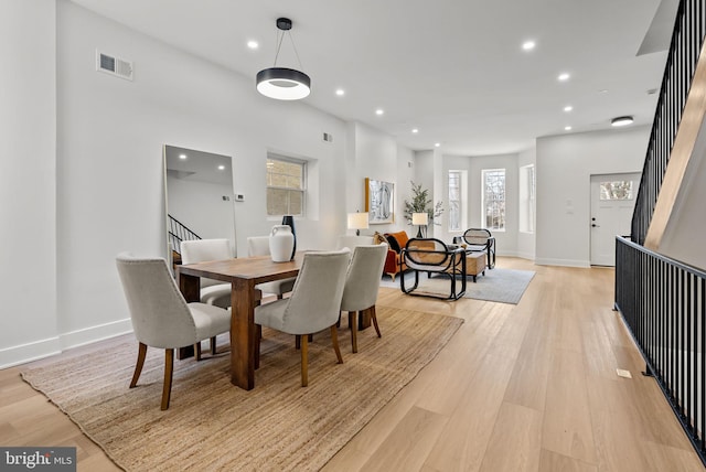 dining area with stairway, visible vents, light wood finished floors, and recessed lighting