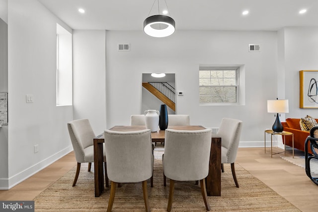 dining space with light wood finished floors, visible vents, and recessed lighting