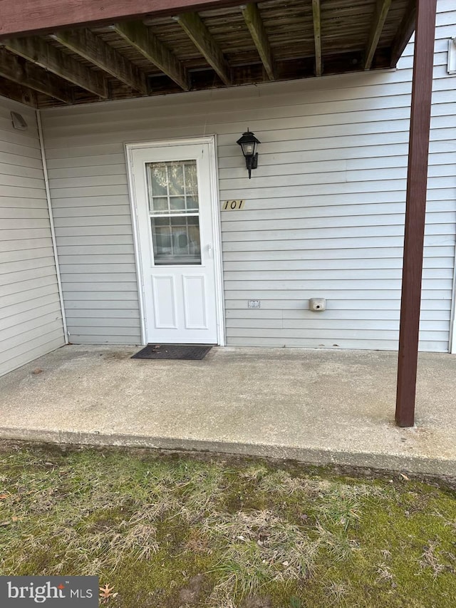 view of exterior entry featuring a patio