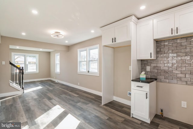 kitchen with white cabinets, decorative backsplash, and dark hardwood / wood-style floors