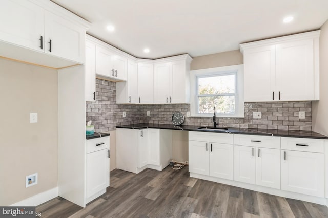 kitchen with white cabinetry, sink, and dark hardwood / wood-style floors