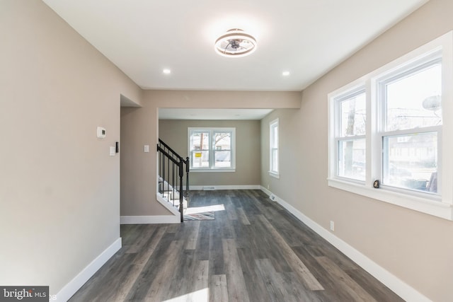 interior space featuring plenty of natural light and dark wood-type flooring