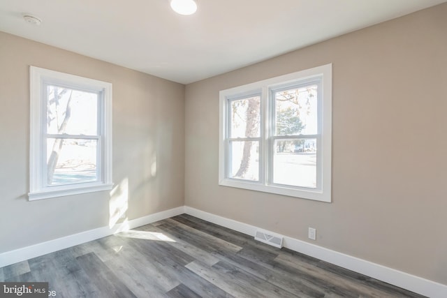 empty room featuring dark wood-type flooring