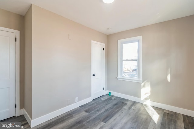 spare room with wood-type flooring