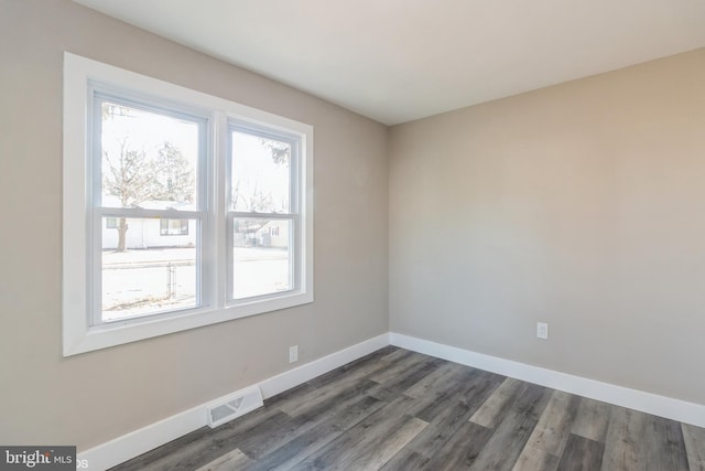 spare room with dark hardwood / wood-style flooring