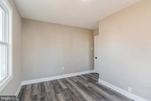 empty room with dark hardwood / wood-style floors