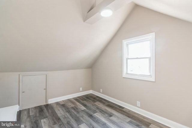 bonus room featuring dark hardwood / wood-style floors and vaulted ceiling