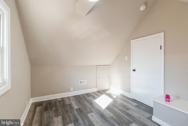 bonus room featuring wood-type flooring and vaulted ceiling