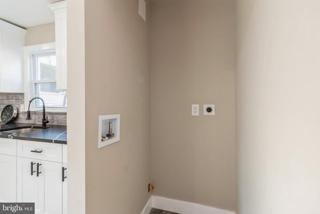 laundry room featuring cabinets, sink, washer hookup, and hookup for an electric dryer