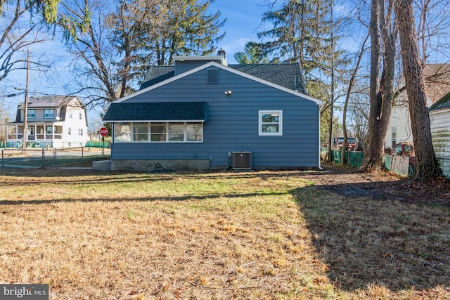 view of side of home featuring a lawn and cooling unit