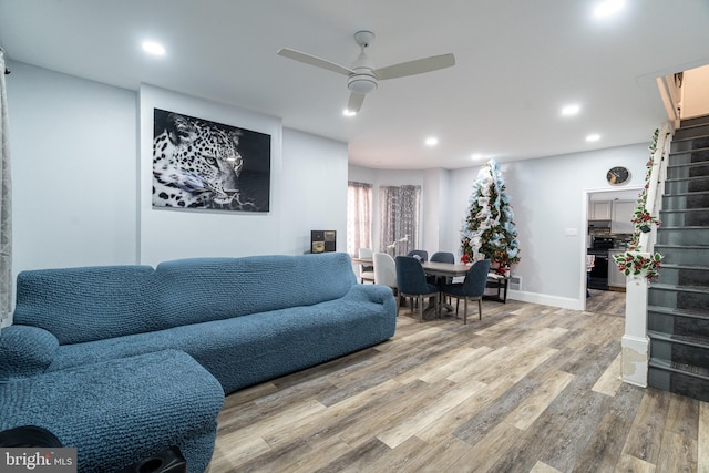 living room with ceiling fan and wood-type flooring