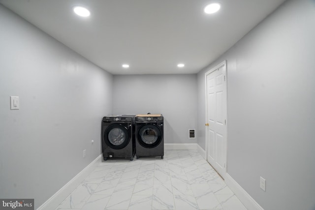 laundry area with washing machine and clothes dryer