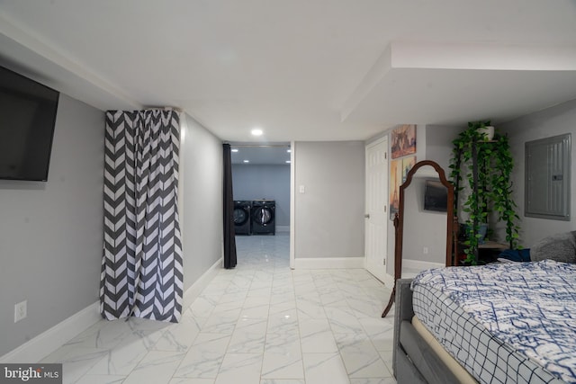 bedroom featuring electric panel and washer and clothes dryer