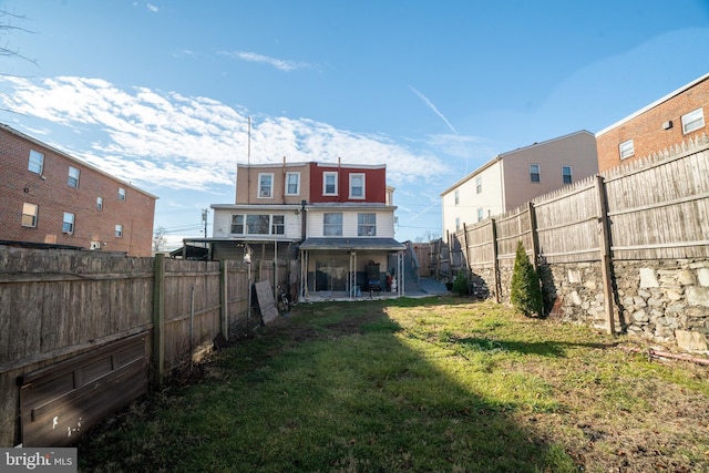 back of property featuring a lawn and a patio