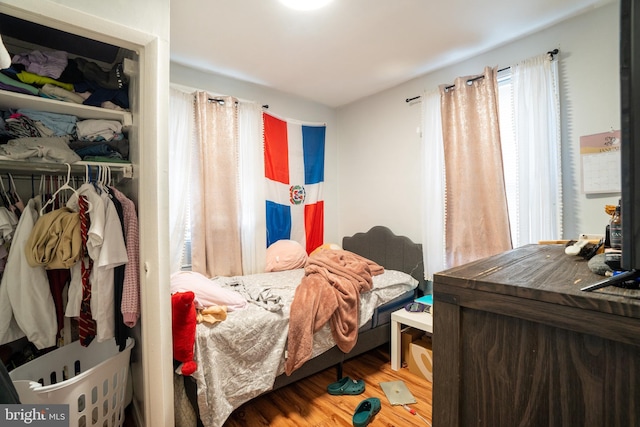 bedroom featuring hardwood / wood-style floors and a closet