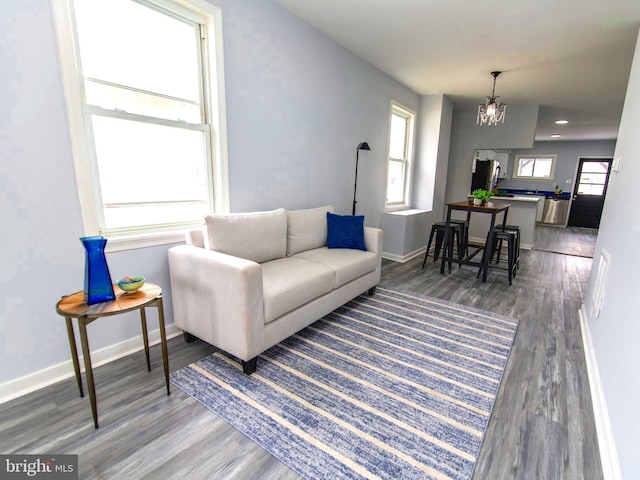 living room with hardwood / wood-style floors and a chandelier