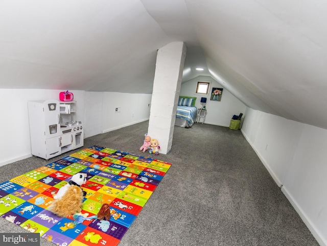 playroom with dark colored carpet and lofted ceiling