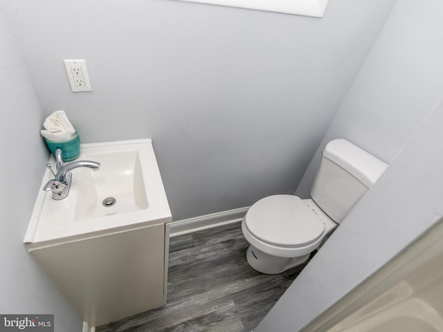 bathroom with vanity, wood-type flooring, and toilet