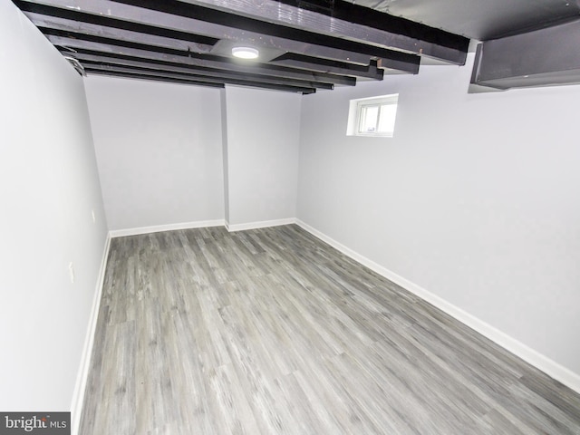 basement with hardwood / wood-style floors