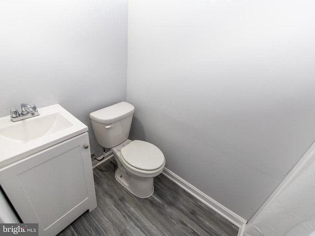 bathroom featuring hardwood / wood-style flooring, vanity, and toilet