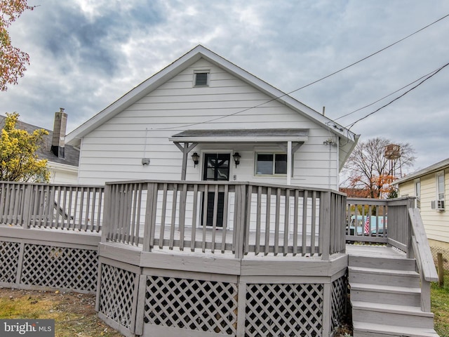 back of house featuring a deck