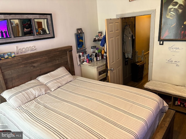 bedroom with a closet and dark hardwood / wood-style floors