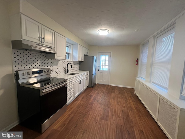 kitchen featuring dark wood-type flooring, sink, tasteful backsplash, white cabinetry, and stainless steel appliances