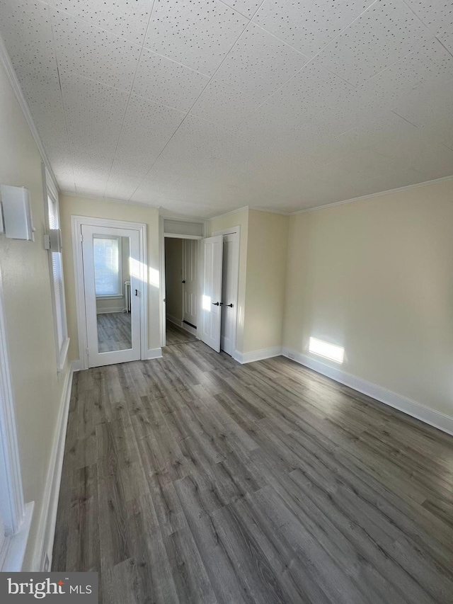 unfurnished room with hardwood / wood-style floors