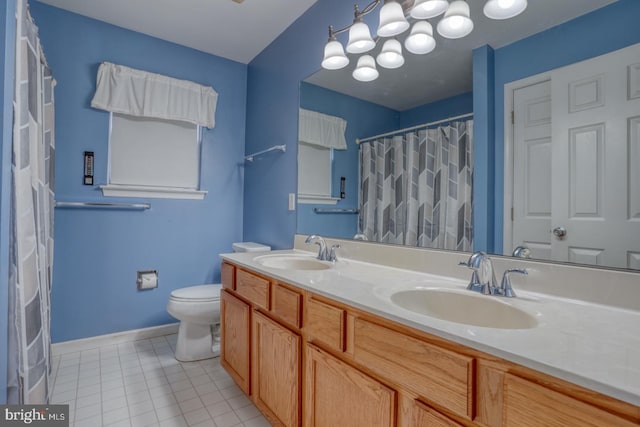 bathroom with tile patterned flooring, vanity, and toilet