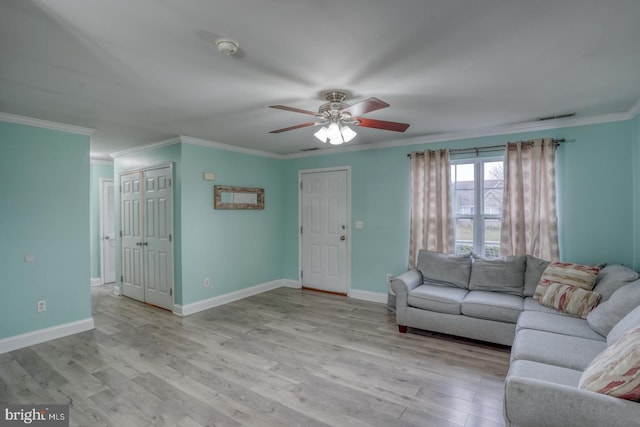 unfurnished living room with ceiling fan, light hardwood / wood-style floors, and ornamental molding