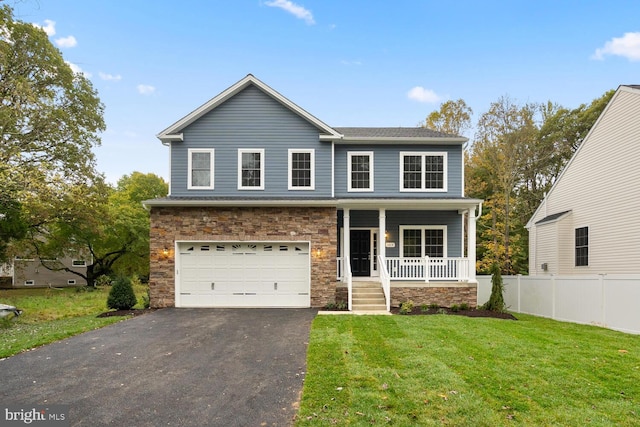 view of front of house with a porch, a front yard, and a garage