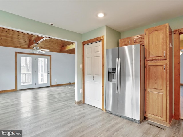 kitchen featuring ceiling fan, light brown cabinets, beamed ceiling, stainless steel refrigerator with ice dispenser, and light hardwood / wood-style floors