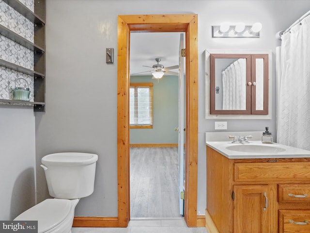 bathroom with ceiling fan, toilet, and vanity