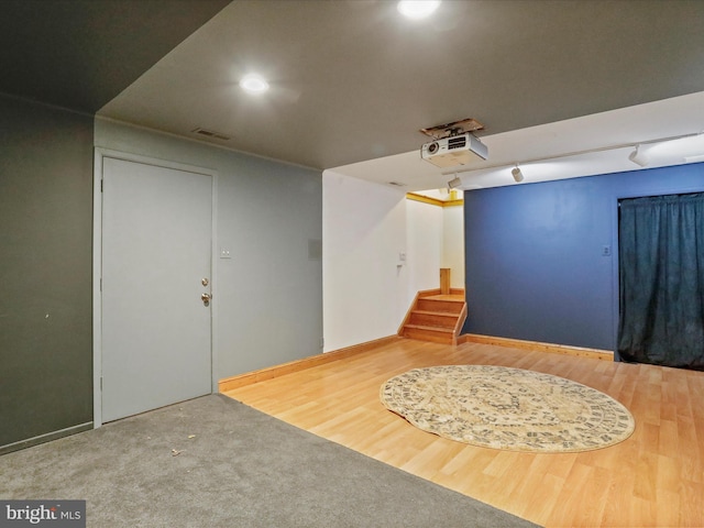 interior space featuring wood-type flooring and track lighting