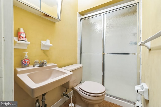 bathroom featuring toilet and an enclosed shower