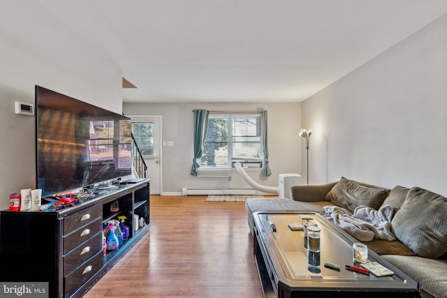 living room featuring baseboard heating and light hardwood / wood-style floors