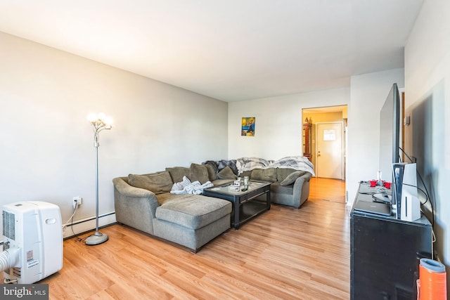 living room with light hardwood / wood-style floors and a baseboard radiator