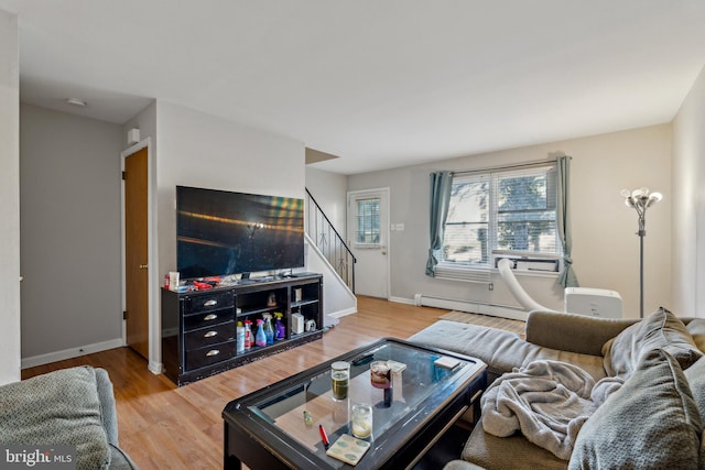 living room with hardwood / wood-style flooring and a baseboard heating unit