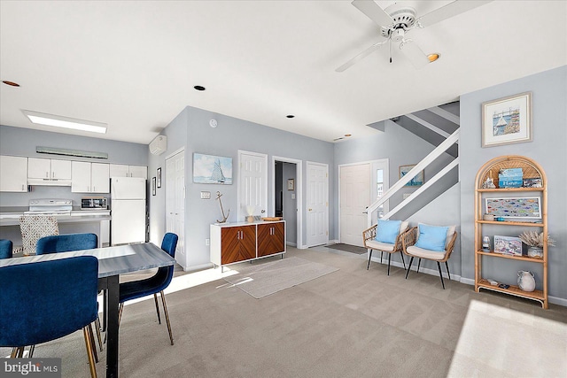 carpeted dining room with ceiling fan