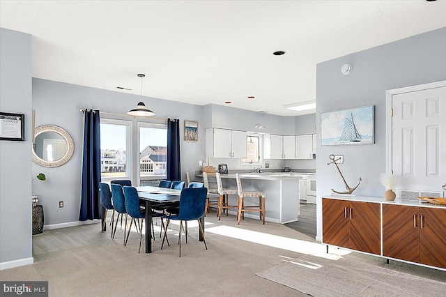 dining room with light colored carpet