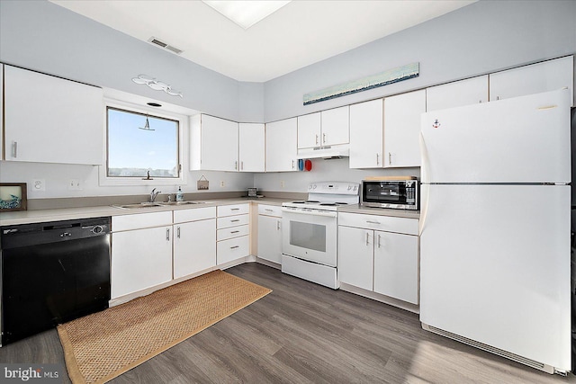 kitchen featuring hardwood / wood-style floors, white appliances, white cabinetry, and sink