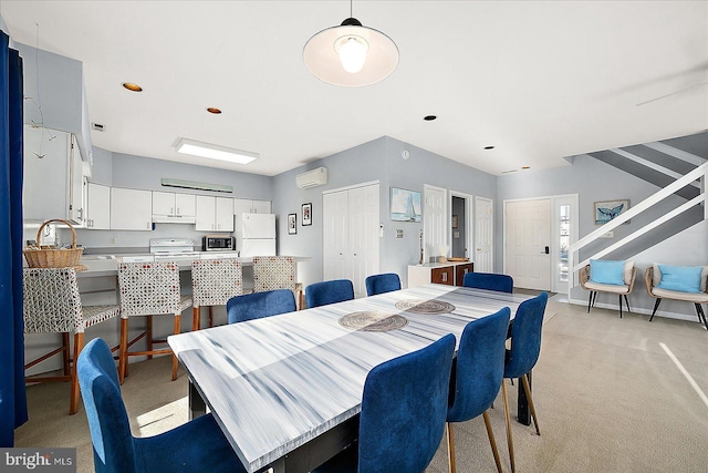 dining space featuring an AC wall unit and light colored carpet