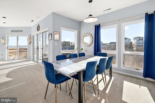 dining area featuring carpet flooring and a healthy amount of sunlight