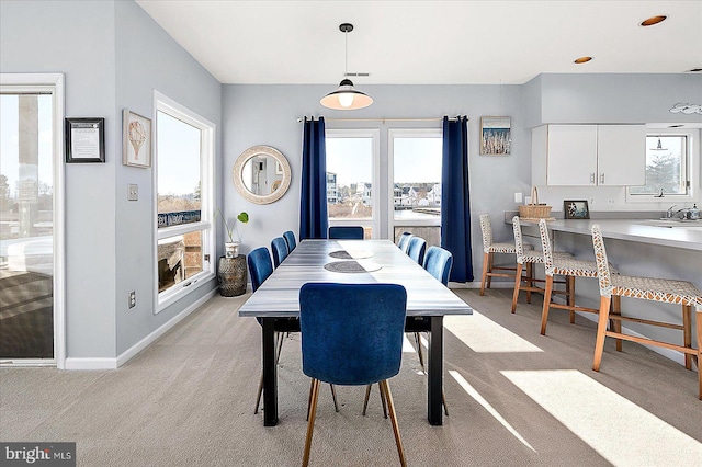 carpeted dining space featuring sink