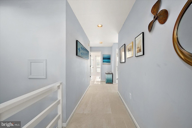 hallway with light colored carpet