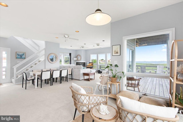 carpeted dining room with ceiling fan