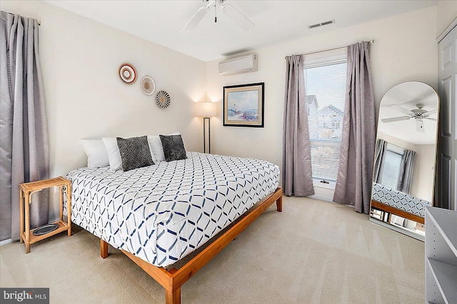 carpeted bedroom with ceiling fan and an AC wall unit