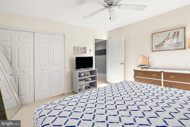 carpeted bedroom featuring ceiling fan and a closet