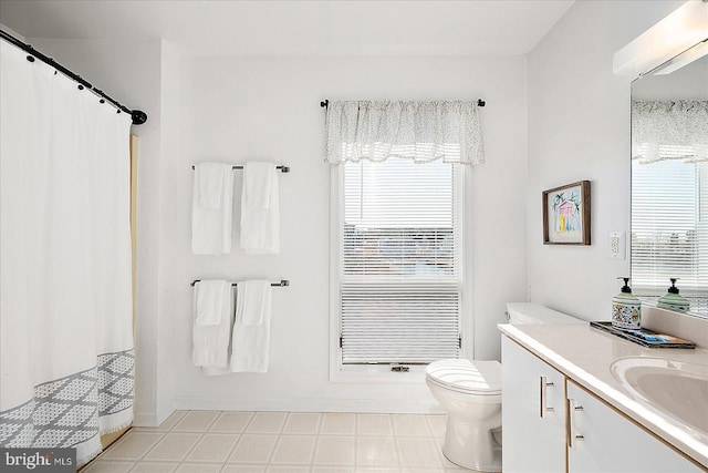 bathroom with vanity, toilet, and curtained shower