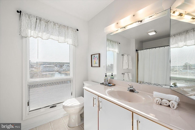 bathroom featuring tile patterned flooring, vanity, and toilet